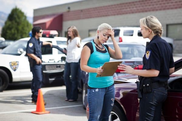 A woman talking to the police after getting into a car accident.