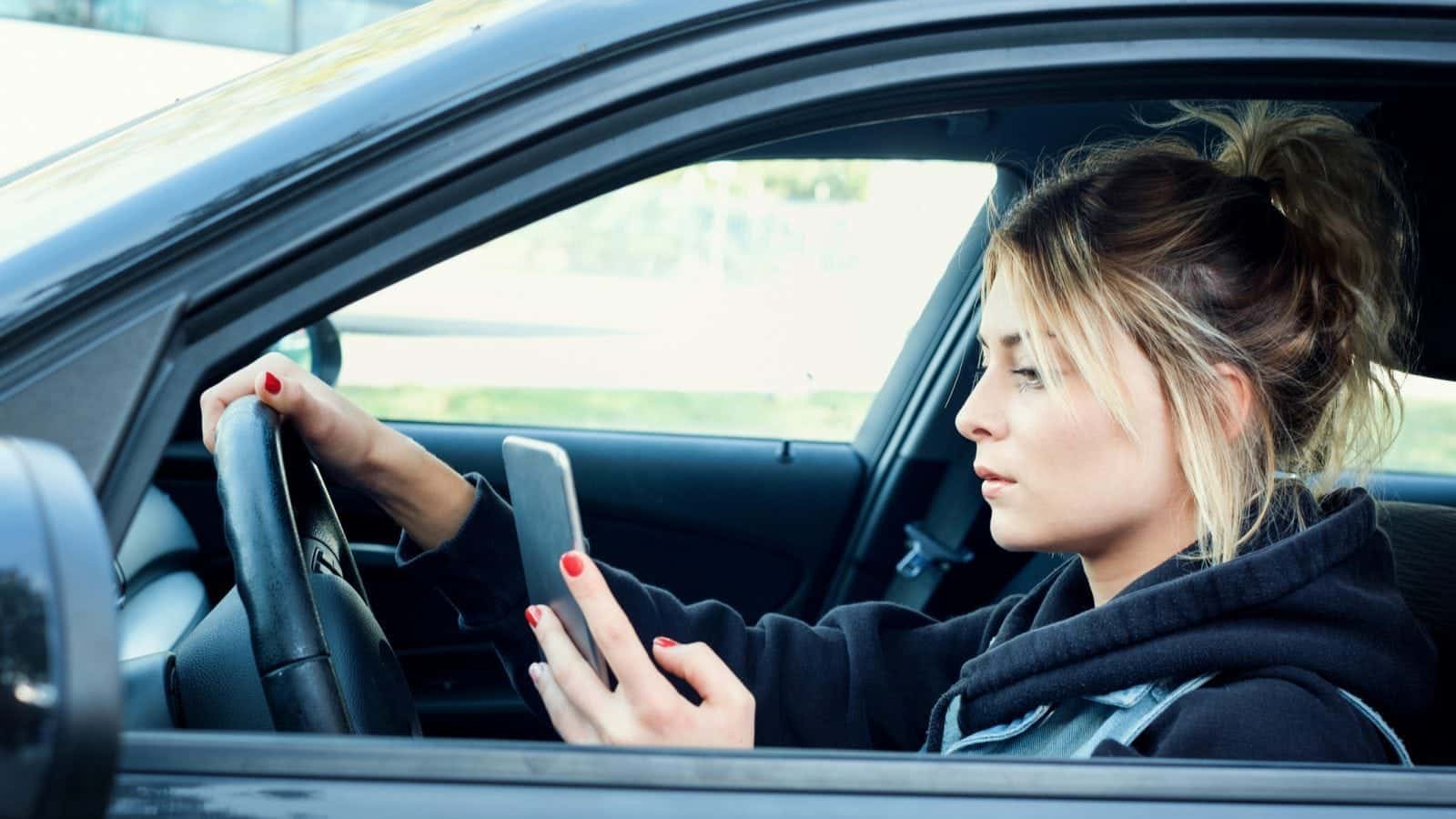 Distracted Woman Driving Stock Photo
