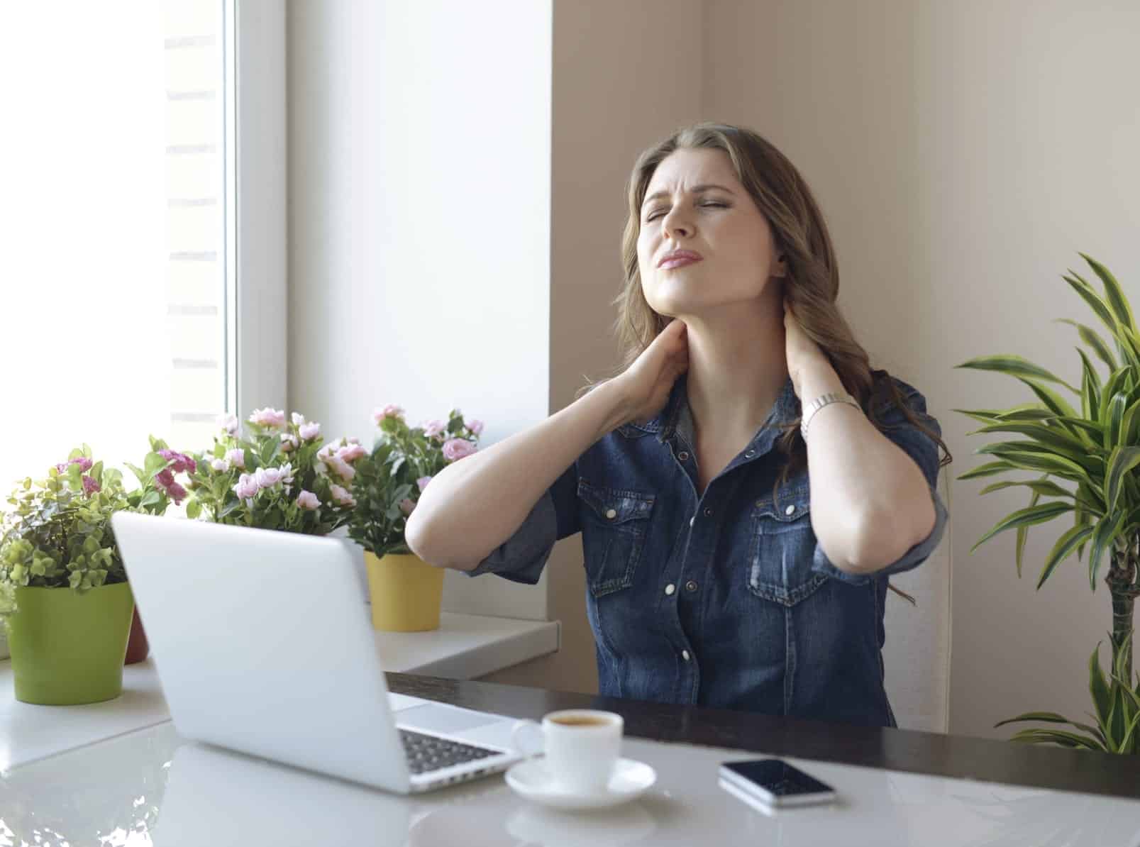 Young Woman With Neck Pain Stock Photo