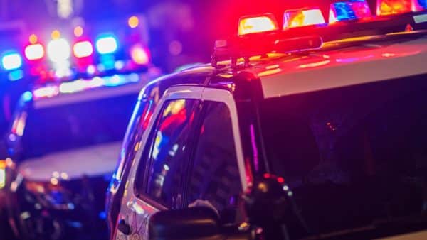 Police Cruiser Parked On A City Street At Night Stock Photo